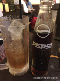A bottle of pepsi paired with shochu and ice.